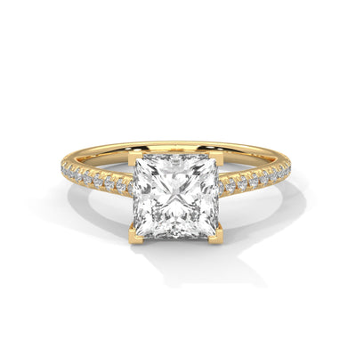 Gold ring with a large diamond and smaller diamonds on the band against a white background