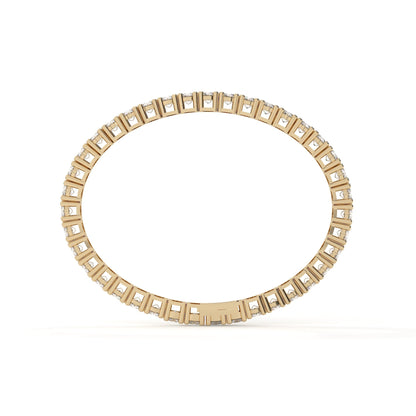Gold ring with square-cut gemstones on a white background