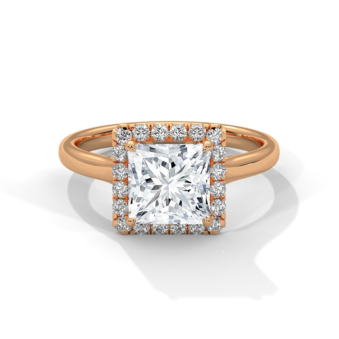 Rose gold ring with a large diamond and smaller diamonds around on a white background