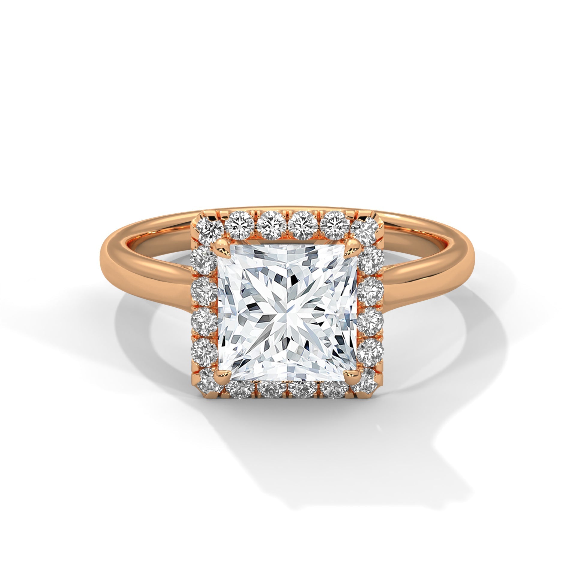 Rose gold ring with a large diamond and smaller diamonds around on a white background