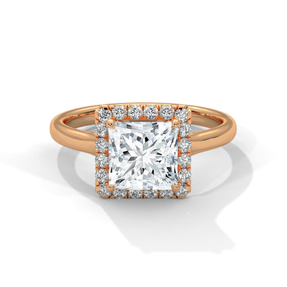 Rose gold ring with a large diamond and smaller diamonds around on a white background