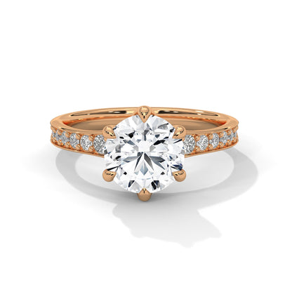 Rose gold ring with a large diamond and smaller diamonds on the band against a white background