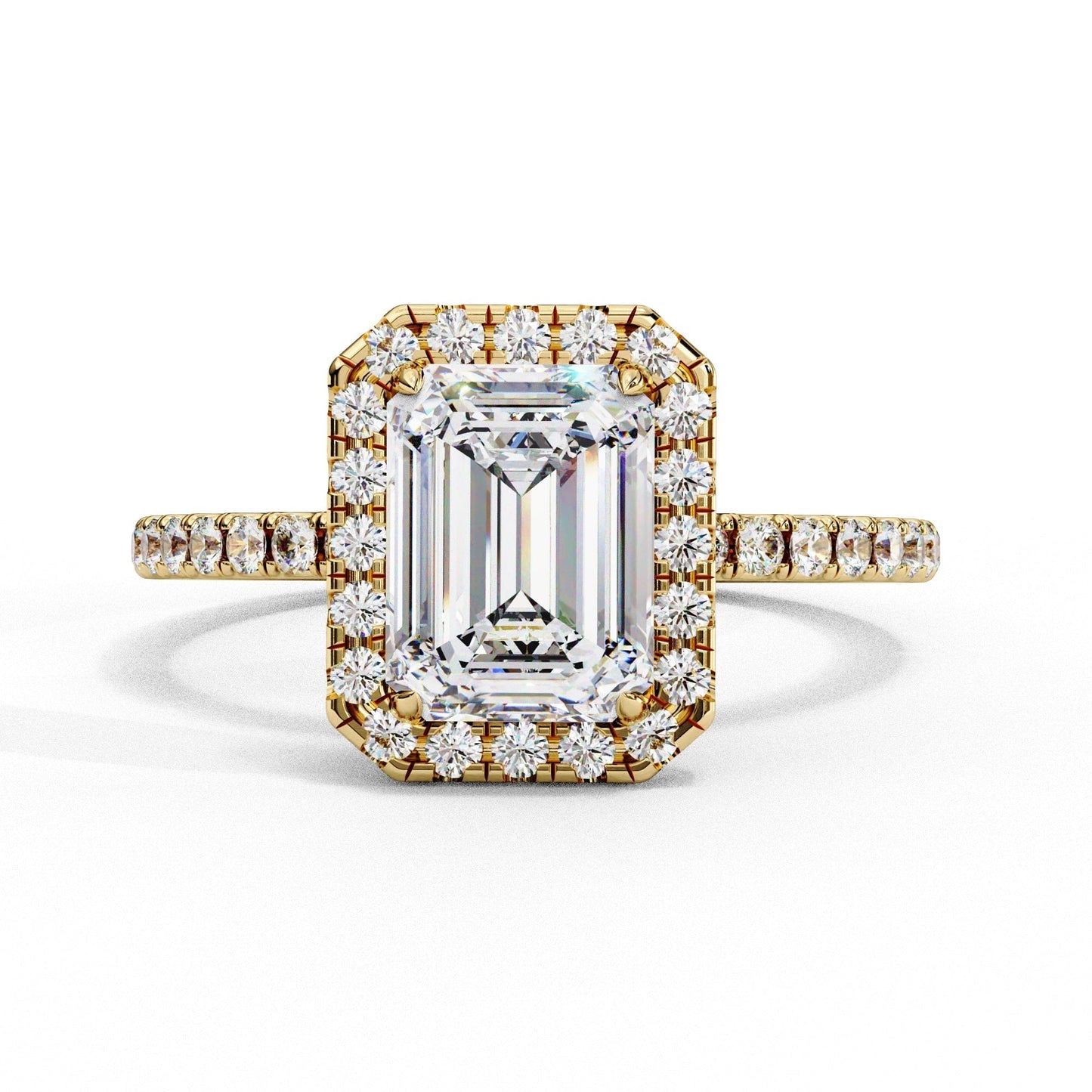Gold ring with emerald-cut diamond and smaller diamonds on a white background