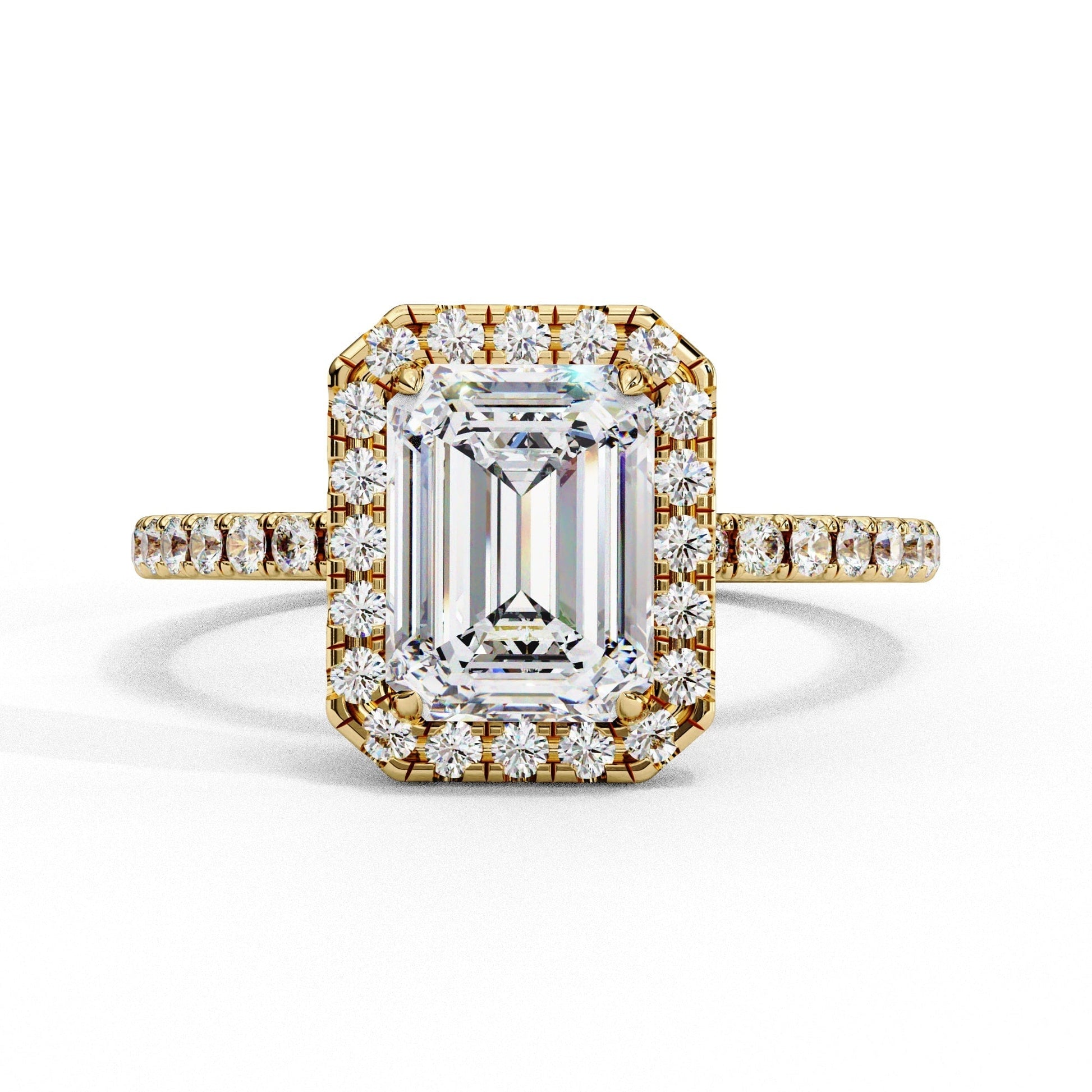 Gold ring with emerald-cut diamond and smaller diamonds on a white background