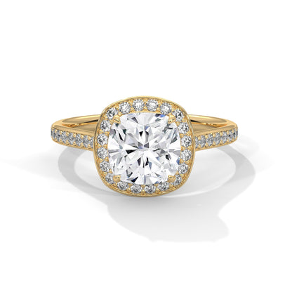 Gold ring with a large diamond and smaller diamonds on the band against a white background