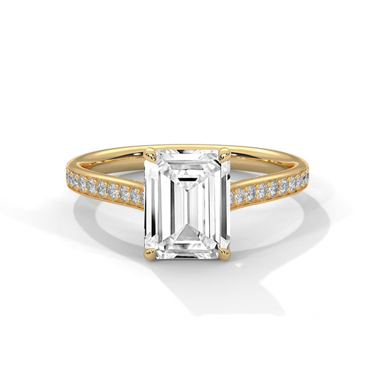 Gold ring with a large diamond and smaller diamonds on the band against a white background
