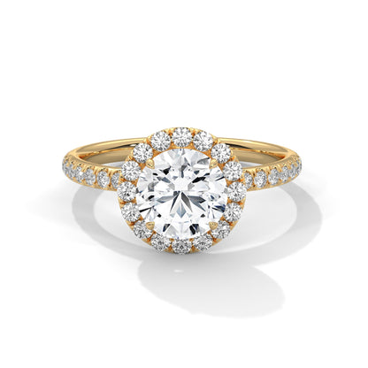 Gold ring with a large diamond and smaller diamonds on the band against a white background
