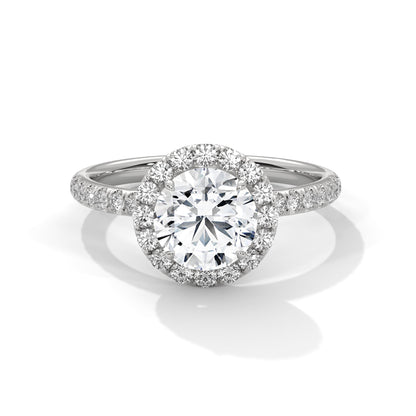 Diamond ring with a halo on a white background