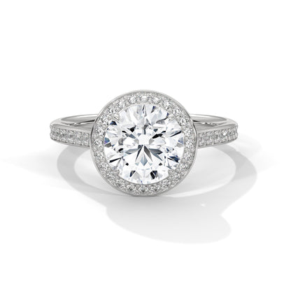 Diamond ring with a white gemstone and diamond-studded band on a white background