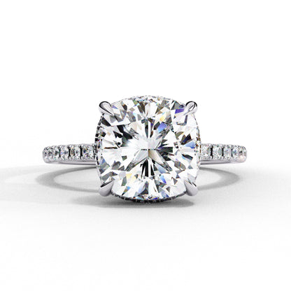 Diamond ring with a large central gemstone and smaller stones on a white background