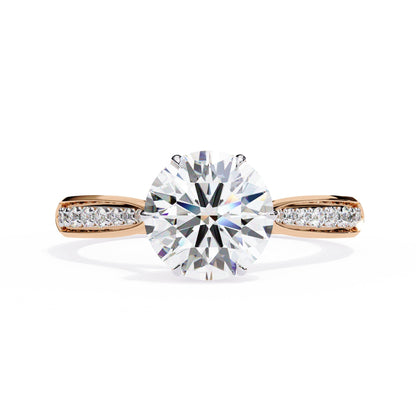 Rose gold ring with a large diamond and smaller diamonds on the band against a white background
