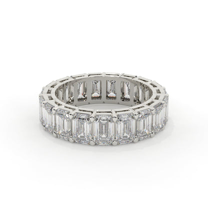 Diamond ring with emerald-cut stones on a white background