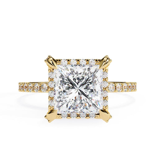 Gold ring with a large diamond and smaller diamonds on the band against a white background