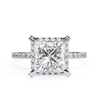 Diamond ring with a large central gemstone and smaller stones on the band against a white background