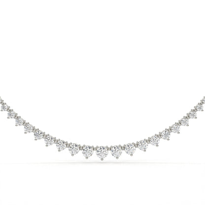 Delicate silver necklace with small diamonds on a white background