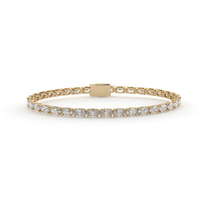 Gold bracelet with diamond accents on a white background