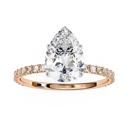Rose gold ring with a pear-shaped diamond on a white background