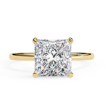 Gold ring with a large diamond on a white background