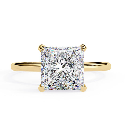 Gold ring with a large diamond on a white background