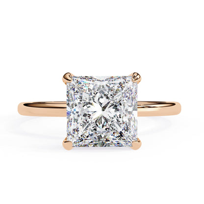 Rose gold ring with a large diamond on a white background