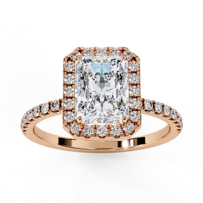 Rose gold ring with a large diamond and smaller diamonds on the band against a white background