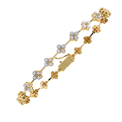 Gold bracelet with floral designs and clear stones on a white background