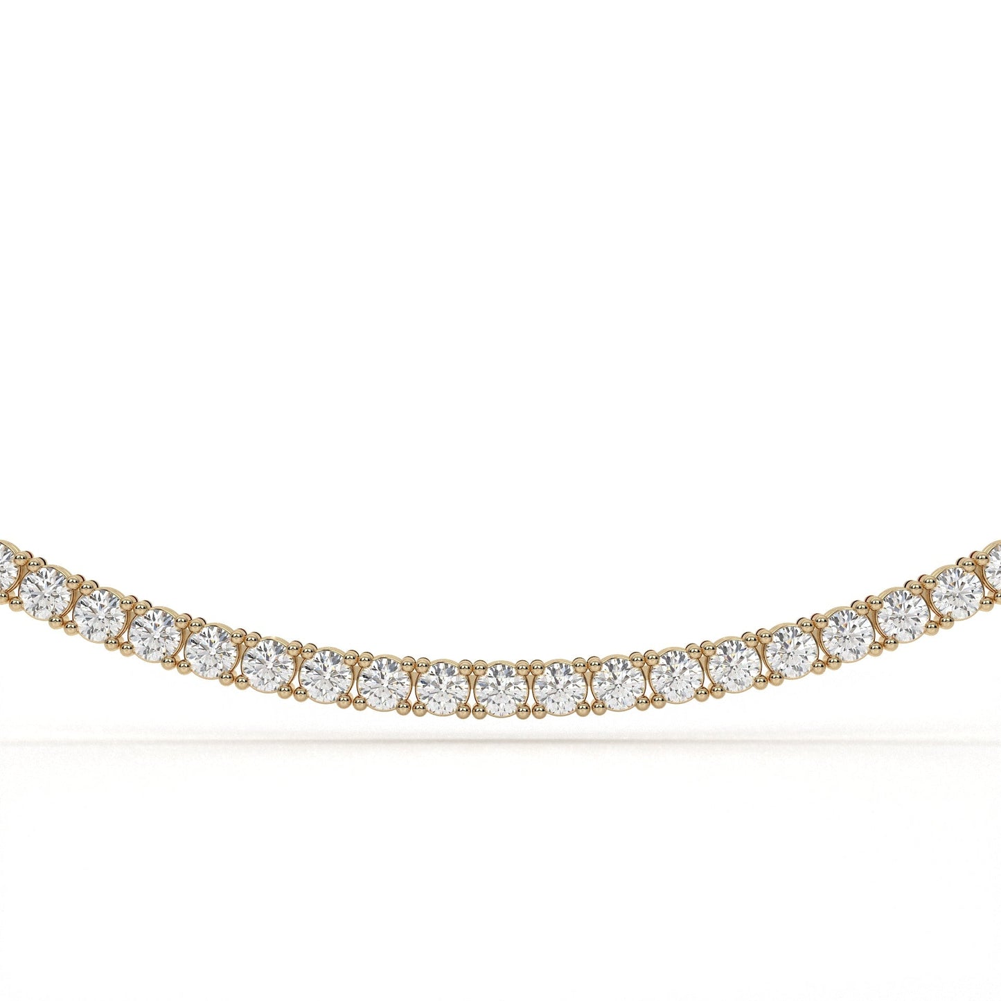 Gold necklace with clear gemstones on a white background