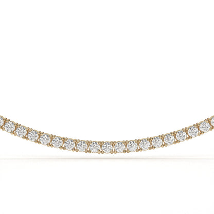 Gold necklace with clear gemstones on a white background