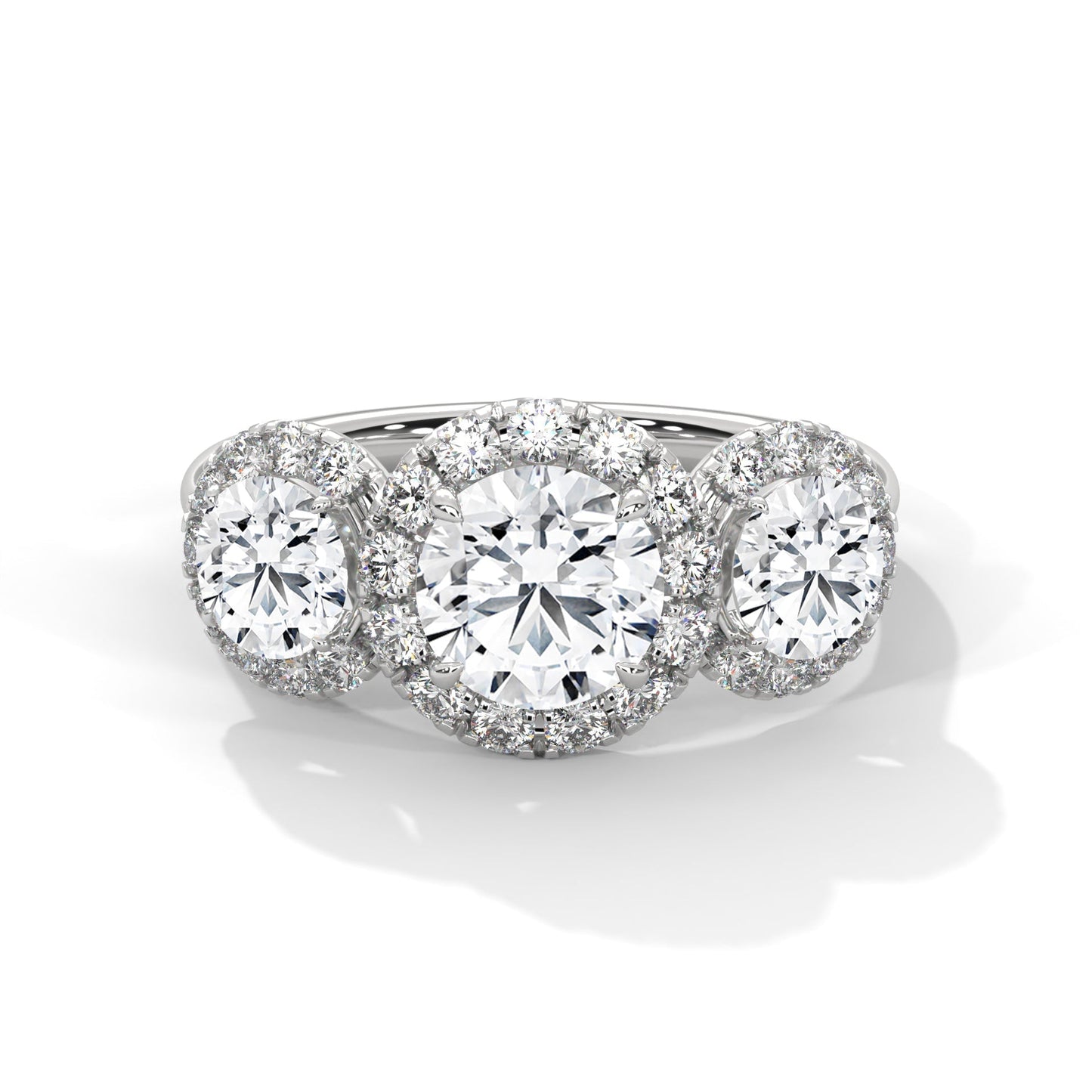 Diamond ring with three circular diamonds on a white background
