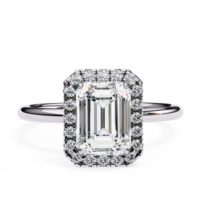 Diamond ring with emerald-cut center stone and halo on a white background