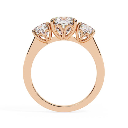 Rose gold ring with three diamonds on a white background
