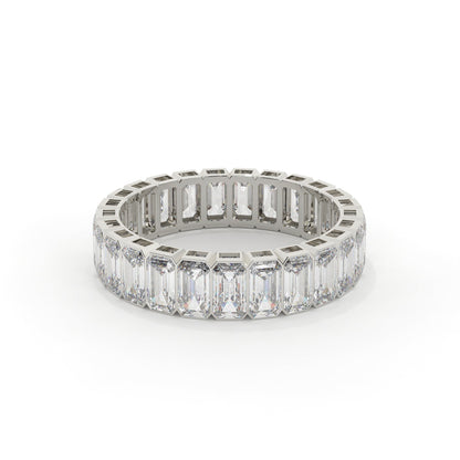 Diamond ring with emerald-cut stones on a white background