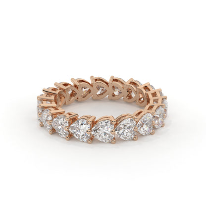 Rose gold ring with heart-shaped diamonds on a white background