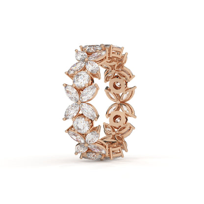 Rose gold ring with diamond accents on a white background