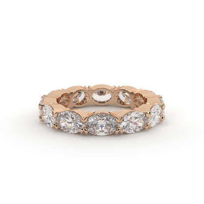 Rose gold ring with multiple diamonds on a white background