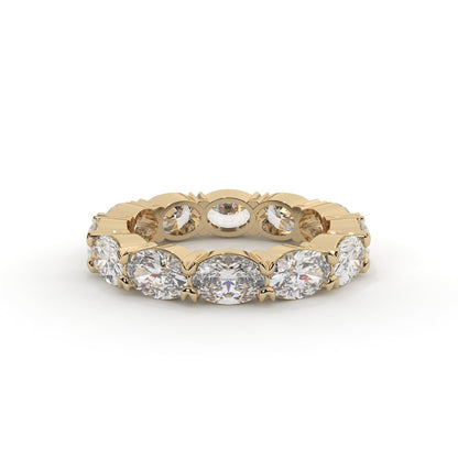 Gold ring with embedded diamonds on a white background