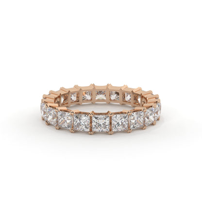 Rose gold eternity ring with diamonds on a white background