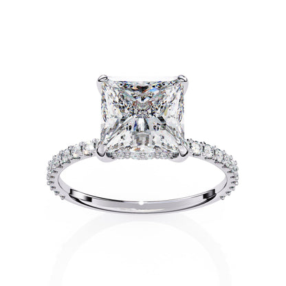 Diamond ring with a prominent princess-cut diamond on a white background