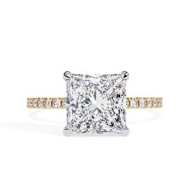 Diamond ring with a yellow gold band on a white background
